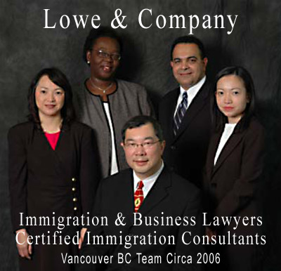 Jeffrey Lowe, seated with his multilingual, international  team of immigration lawyer, notary and certified canada immigration consultants circa 2005